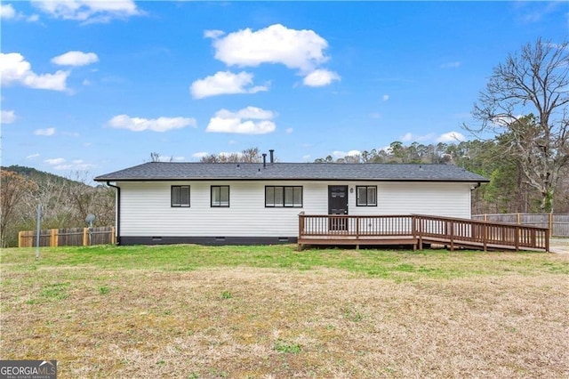 rear view of house featuring crawl space, fence, a deck, and a yard