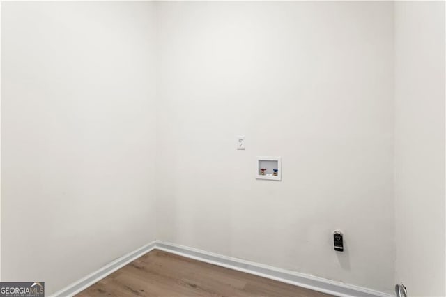 laundry room featuring laundry area, hookup for a washing machine, baseboards, and wood finished floors