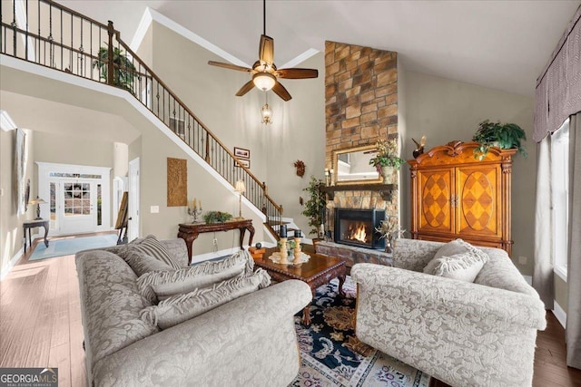 living area featuring hardwood / wood-style flooring, plenty of natural light, stairs, and a fireplace