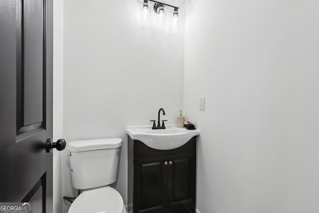 bathroom with toilet and vanity