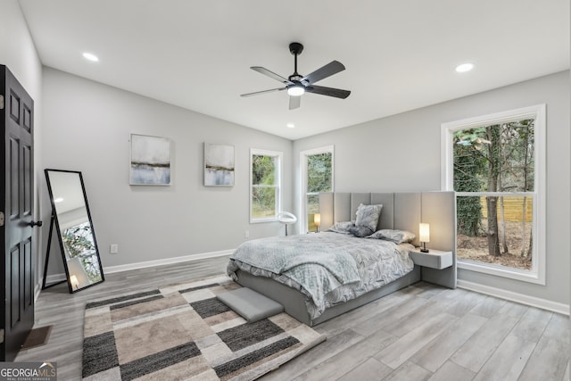 bedroom featuring ceiling fan, baseboards, wood finished floors, and recessed lighting