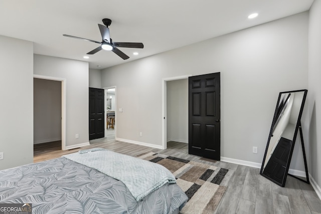 bedroom with light wood-style floors, baseboards, a ceiling fan, and recessed lighting