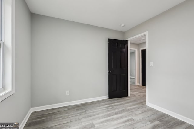 empty room featuring light wood-style floors and baseboards