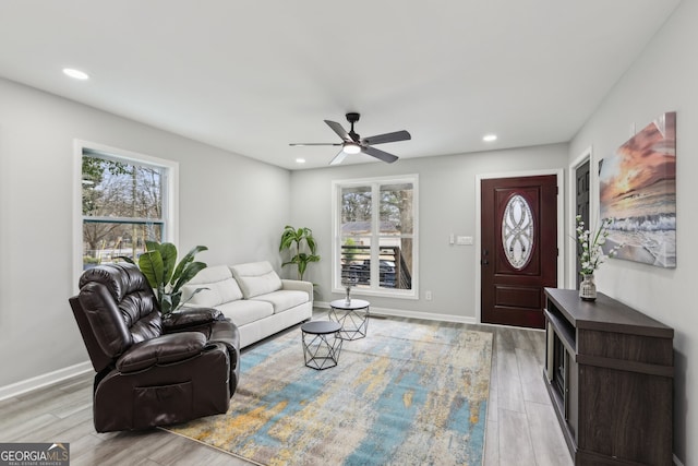 living room with recessed lighting, wood finished floors, and a healthy amount of sunlight