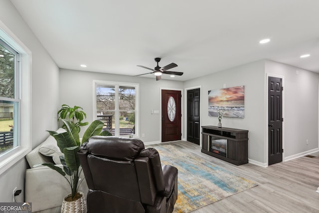 living room with recessed lighting, ceiling fan, baseboards, and wood finished floors