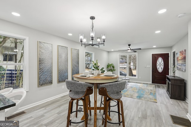 dining area featuring light wood-style floors, recessed lighting, and visible vents