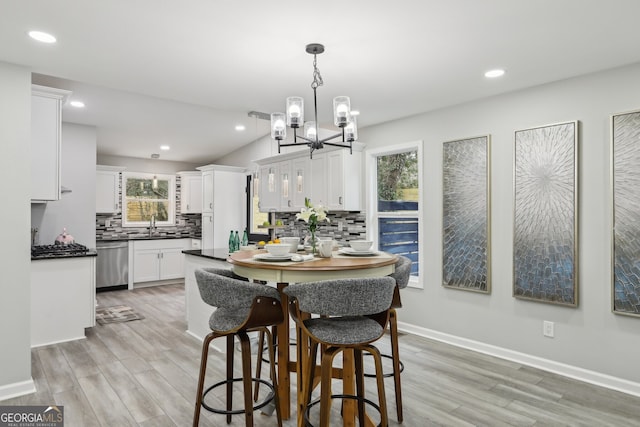 dining area featuring a healthy amount of sunlight, light wood-style flooring, and recessed lighting