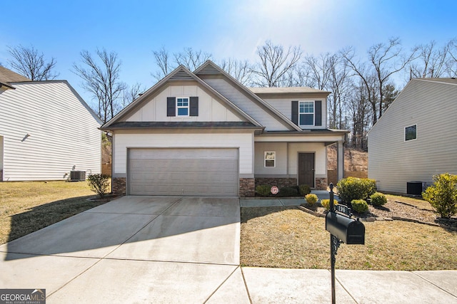 view of front of property with concrete driveway, an attached garage, board and batten siding, fence, and stone siding