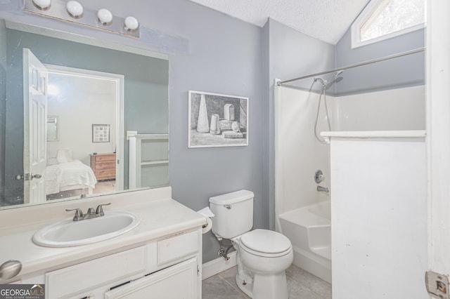 ensuite bathroom featuring toilet, ensuite bathroom, a textured ceiling, vanity, and tile patterned flooring