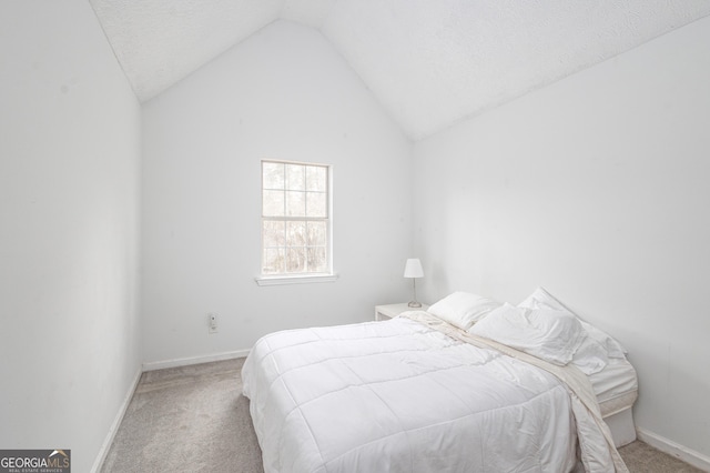 bedroom with carpet, lofted ceiling, and baseboards