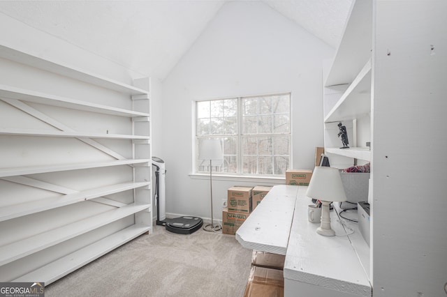 home office with carpet flooring and vaulted ceiling