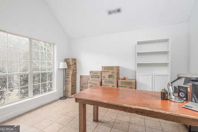 tiled office with visible vents and vaulted ceiling