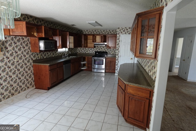 kitchen with dishwashing machine, stainless steel electric range oven, a sink, and wallpapered walls