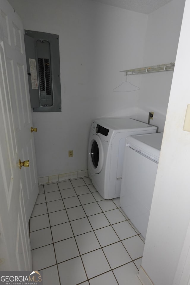 clothes washing area featuring light tile patterned floors, laundry area, separate washer and dryer, and electric panel