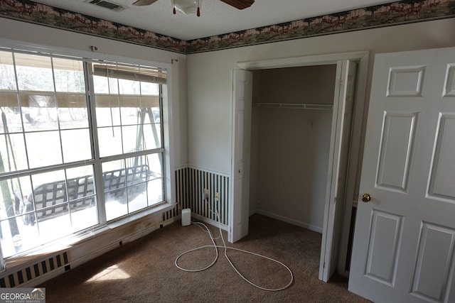 unfurnished bedroom featuring a closet, carpet flooring, visible vents, and multiple windows