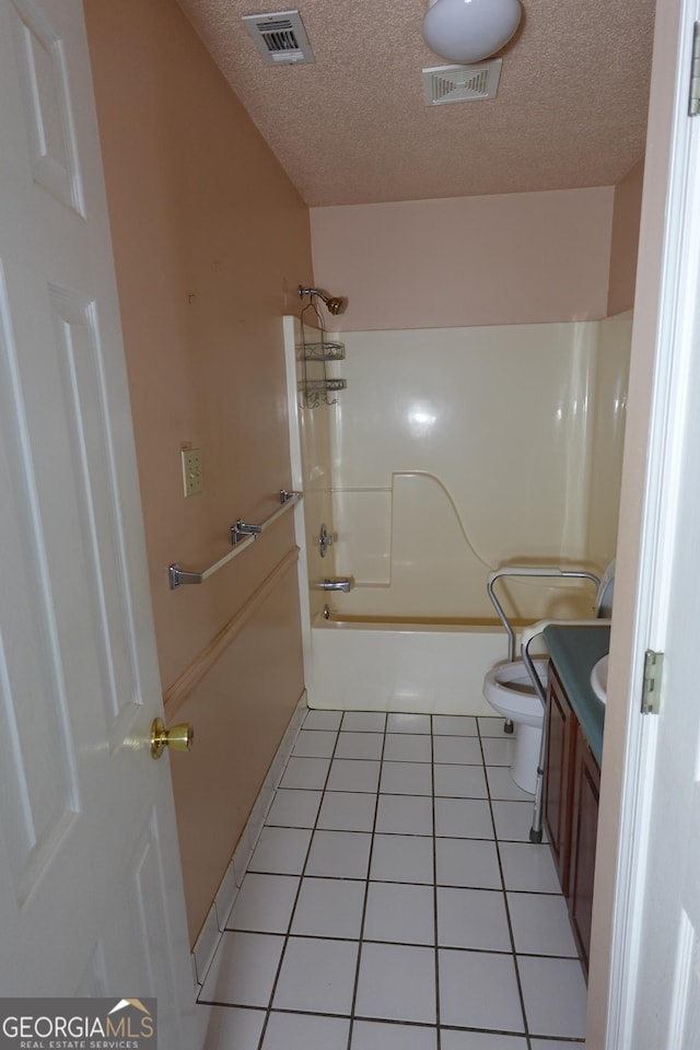 full bathroom featuring visible vents, toilet, vanity, a textured ceiling, and tile patterned flooring