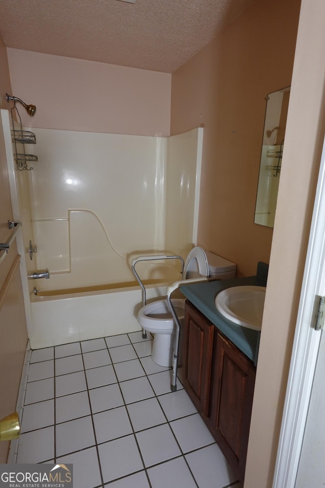 full bath with toilet, tile patterned flooring, a textured ceiling, vanity, and washtub / shower combination