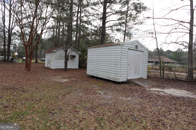 view of shed featuring fence