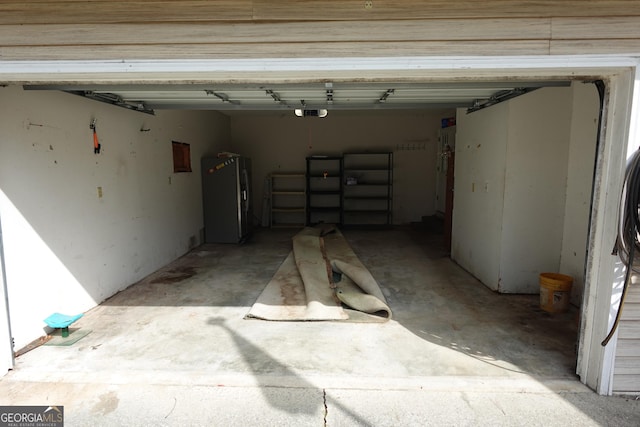 garage featuring a garage door opener and refrigerator