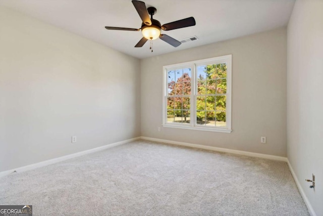 spare room featuring a ceiling fan, carpet flooring, visible vents, and baseboards