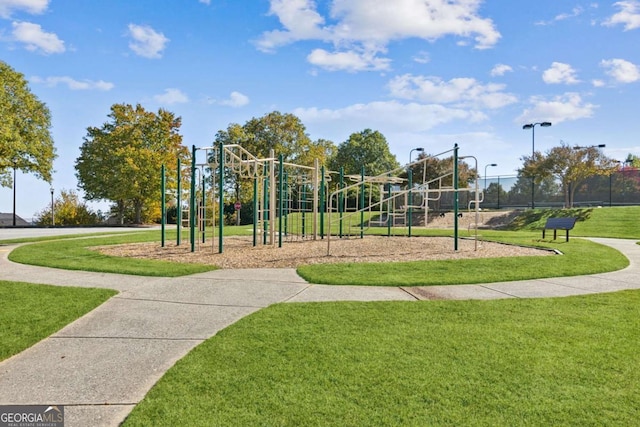 community jungle gym featuring a lawn