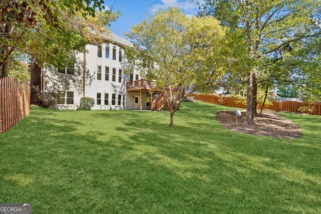 view of yard with a fenced backyard and a wooden deck