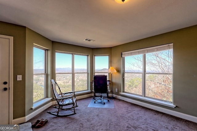 carpeted home office featuring visible vents, a mountain view, and baseboards