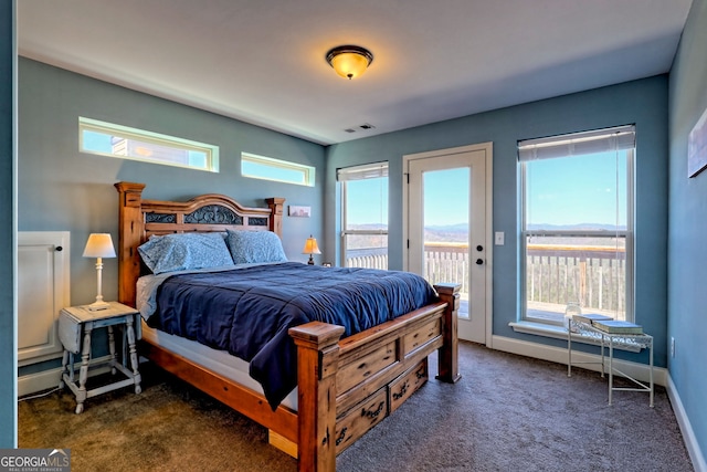 bedroom with visible vents, baseboards, dark colored carpet, and access to outside