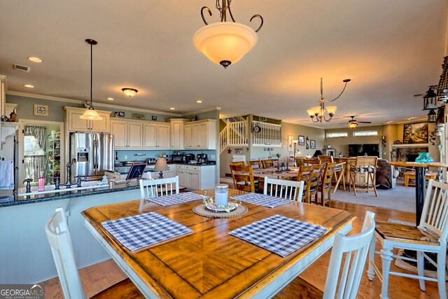 dining room featuring visible vents, crown molding, ceiling fan, recessed lighting, and light wood-style floors