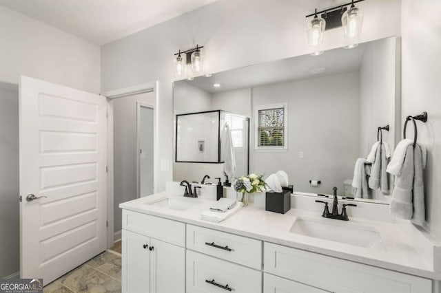 full bathroom with a shower stall, toilet, double vanity, and a sink