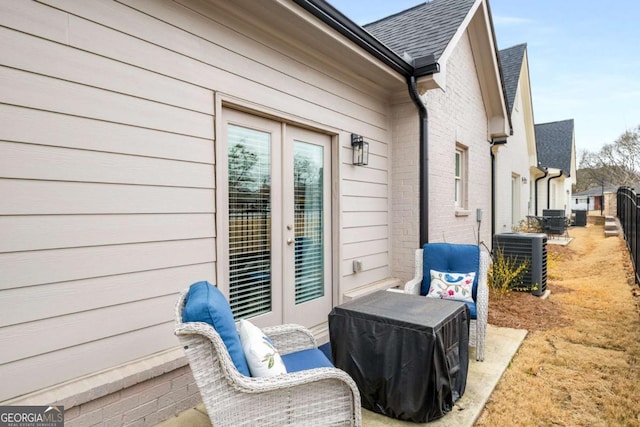 view of patio / terrace featuring central air condition unit and fence