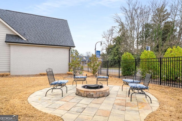 view of patio with fence and a fire pit