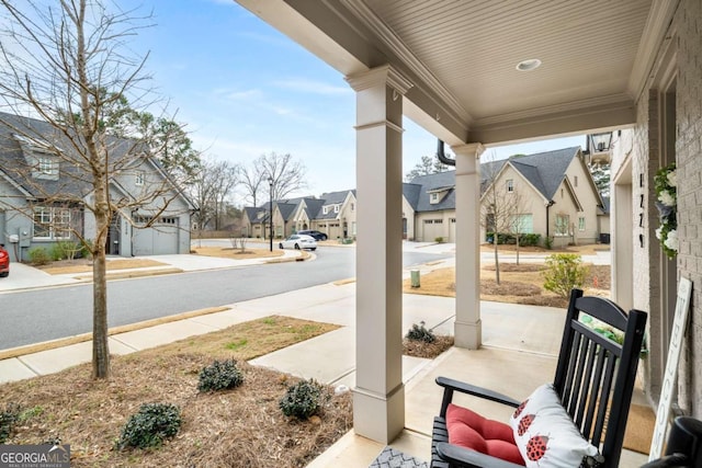 view of patio / terrace with a porch and a residential view