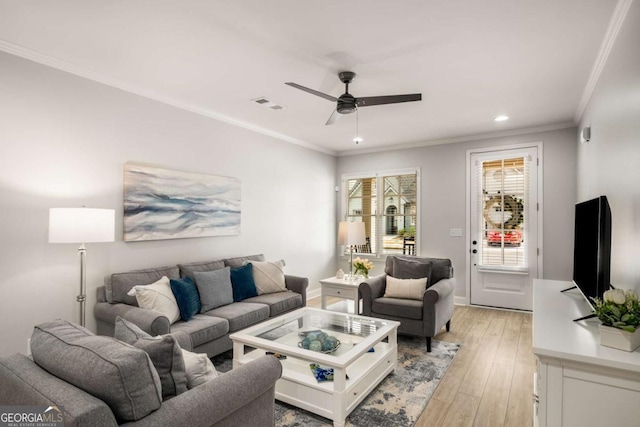 living area with visible vents, crown molding, recessed lighting, light wood-style floors, and a ceiling fan