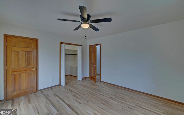 unfurnished bedroom with a closet, ceiling fan, light wood-style flooring, and baseboards