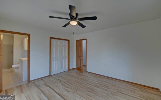 unfurnished bedroom featuring light wood finished floors, a closet, ceiling fan, ensuite bath, and baseboards