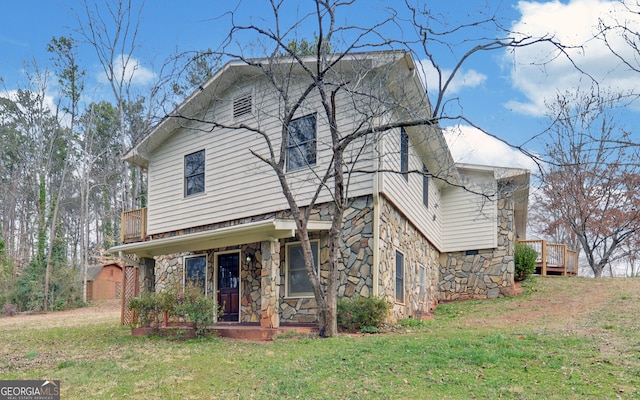 view of front of house with a porch, stone siding, and a front lawn