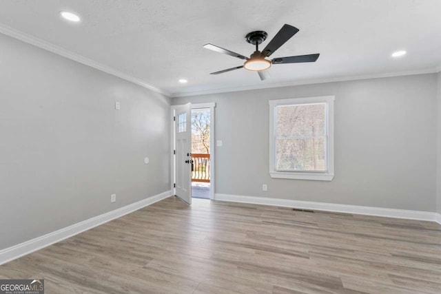 spare room with recessed lighting, crown molding, baseboards, and wood finished floors