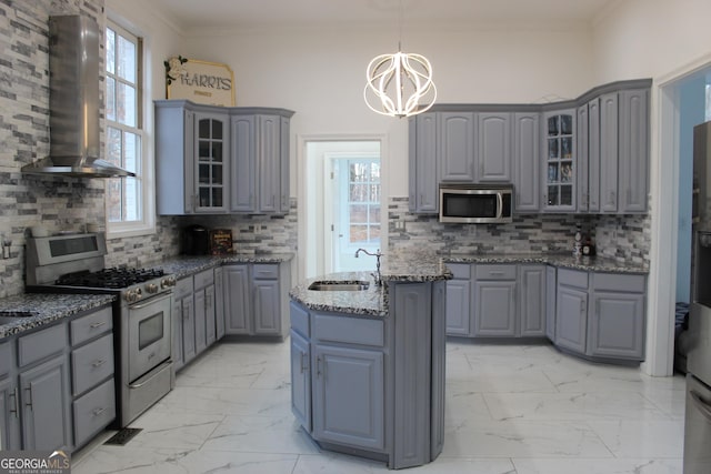 kitchen with appliances with stainless steel finishes, marble finish floor, gray cabinetry, and island exhaust hood