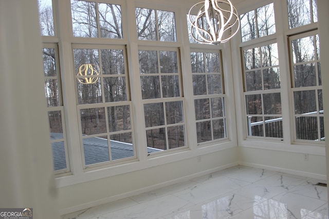 unfurnished sunroom featuring a notable chandelier