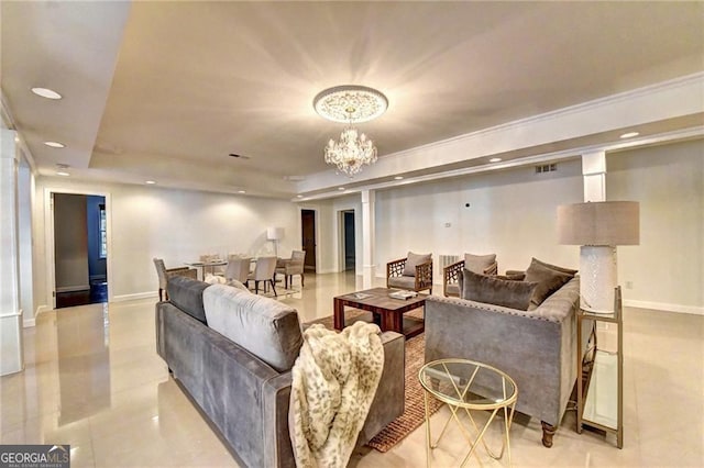 living room with visible vents, an inviting chandelier, baseboards, and a tray ceiling