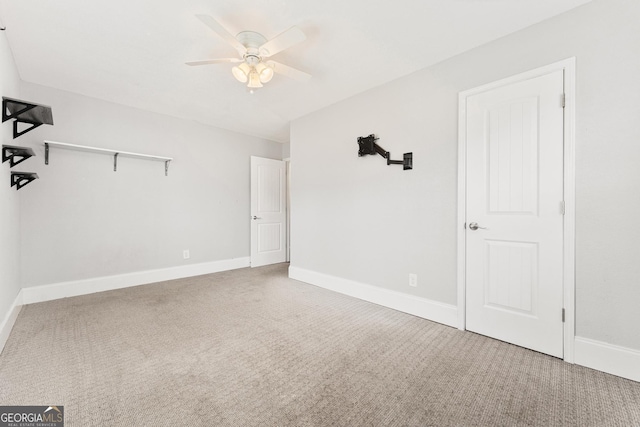 interior space featuring carpet floors, ceiling fan, and baseboards