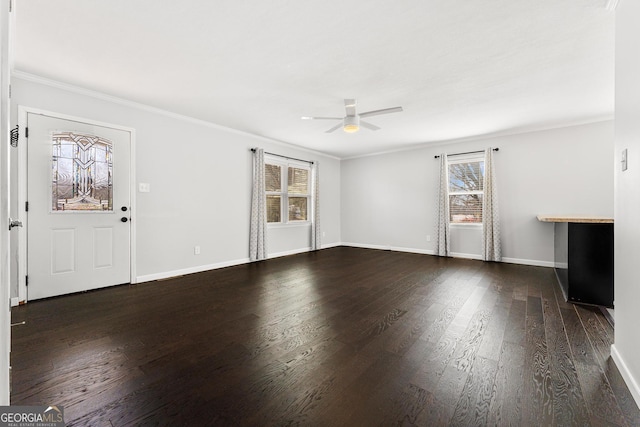 unfurnished living room with ceiling fan, crown molding, baseboards, and wood finished floors