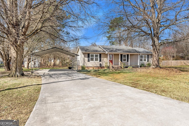 single story home with driveway, a front yard, fence, and a detached carport