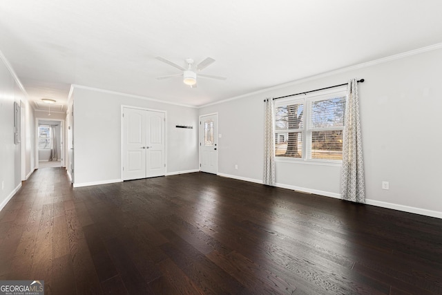 spare room with attic access, dark wood-type flooring, and baseboards