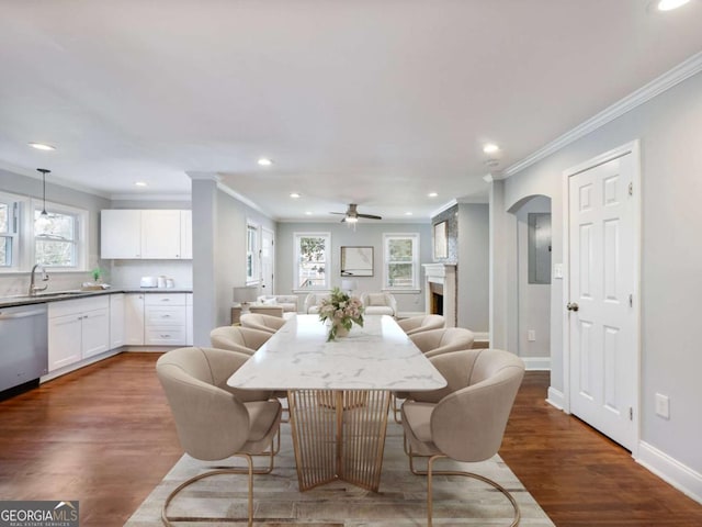 dining area with dark wood-style floors, recessed lighting, a fireplace, and baseboards