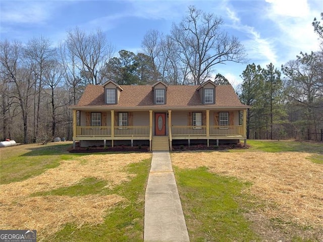 view of front of house featuring covered porch, roof with shingles, and a front yard