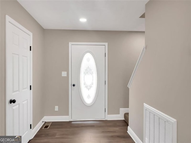 entrance foyer with wood finished floors, visible vents, and baseboards