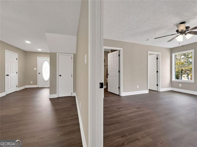 entryway featuring a ceiling fan, dark wood-style flooring, a textured ceiling, and baseboards