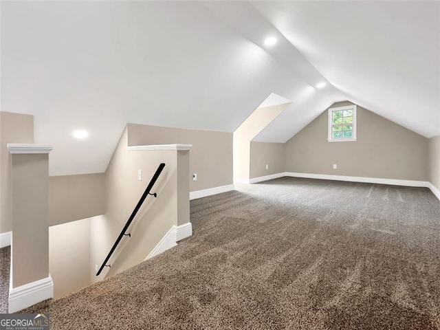 bonus room with carpet, baseboards, and vaulted ceiling